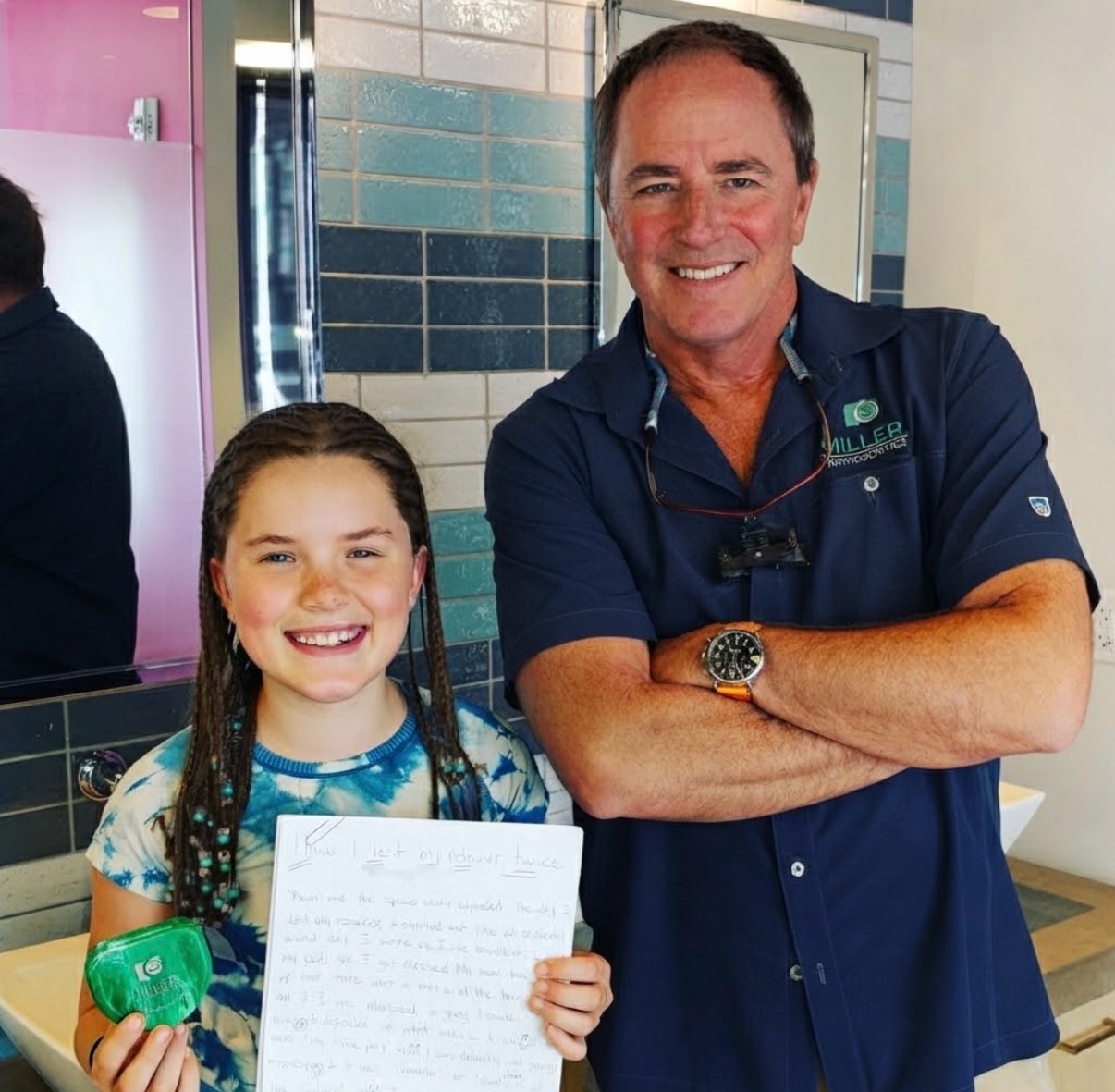 Dr. Robert Miller smiling with a young patient who holds her Miller Orthodontics retainer case and a handwritten story titled How I Lost My Retainer Twice
